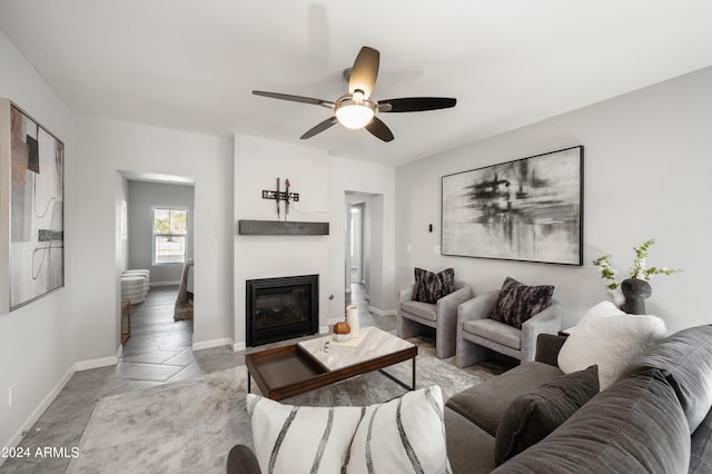 living room featuring ceiling fan and light tile patterned floors