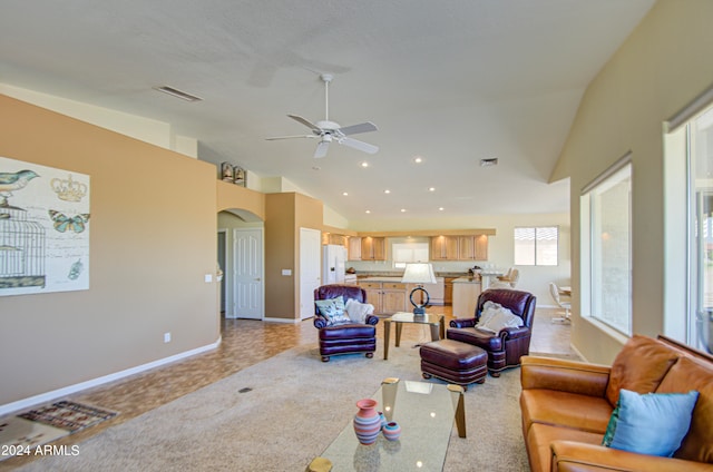 living room featuring light colored carpet, high vaulted ceiling, and ceiling fan