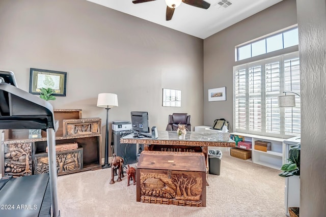 carpeted office with ceiling fan and visible vents