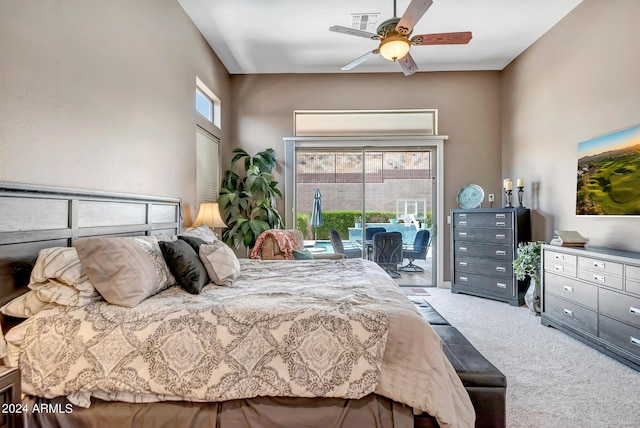 carpeted bedroom featuring access to outside, multiple windows, visible vents, and a ceiling fan