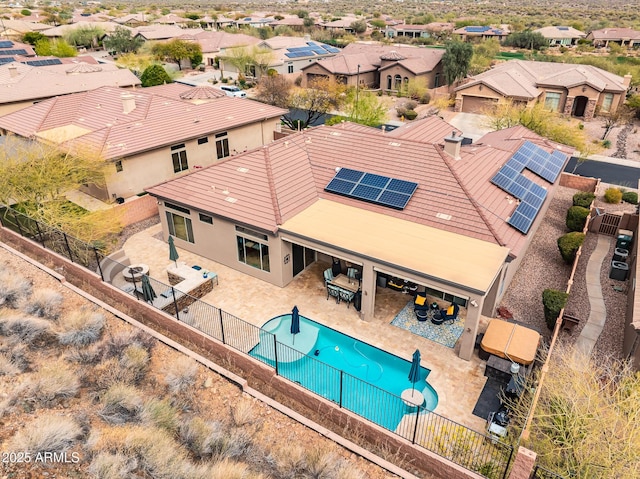 view of swimming pool with a fenced backyard, a residential view, outdoor dining area, and a patio