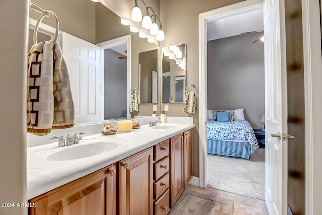 ensuite bathroom featuring connected bathroom, a sink, and double vanity