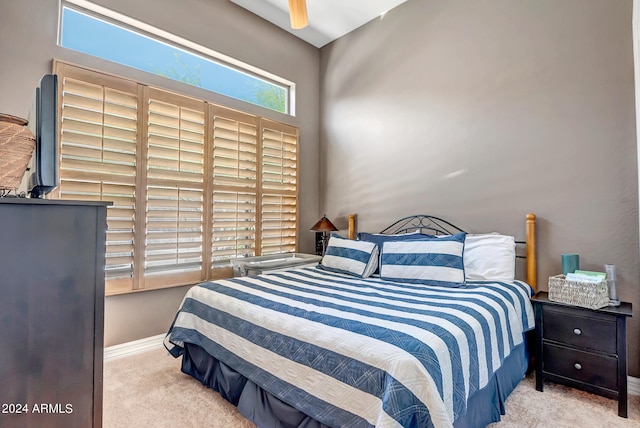 bedroom with ceiling fan and light carpet