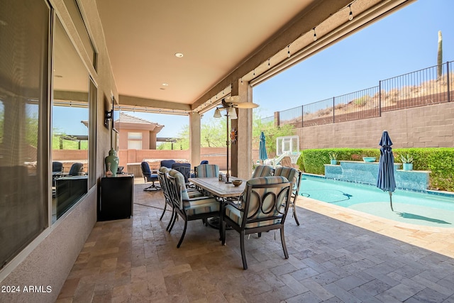 view of patio / terrace with outdoor dining space, a fenced backyard, and a fenced in pool