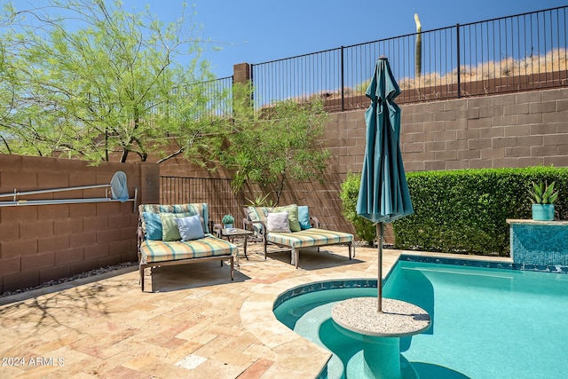 view of swimming pool featuring a fenced in pool, fence, an outdoor hangout area, and a patio