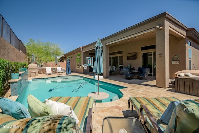 view of swimming pool featuring a patio, outdoor lounge area, grilling area, and a fenced in pool