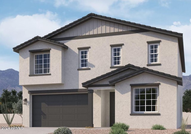 view of front of home with a mountain view and a garage