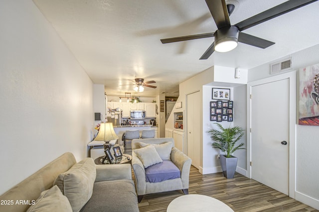2301 E University Dr Unit 488, Mesa, AZ 85213 - living area with a ceiling fan and dark wood-style flooring
