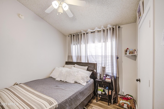 2301 E University Dr Unit 488, Mesa, AZ 85213 - bedroom with a textured ceiling, vaulted ceiling, wood finished floors, and a ceiling fan