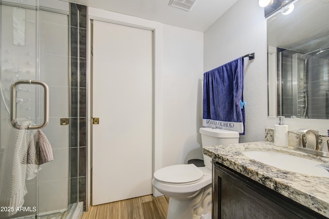 2301 E University Dr Unit 488, Mesa, AZ 85213 - bathroom featuring vanity, a shower stall, wood finished floors, and toilet