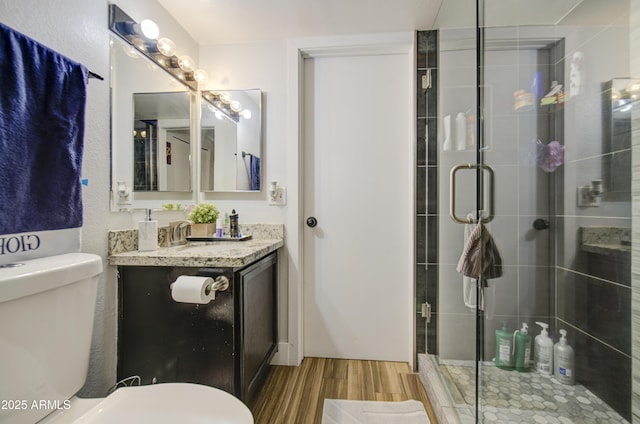 2301 E University Dr Unit 488, Mesa, AZ 85213 - bathroom with wood finished floors, toilet, vanity, and a stall shower