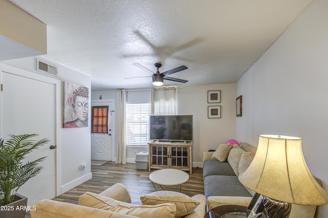 2301 E University Dr Unit 488, Mesa, AZ 85213 - living area with wood finished floors, ceiling fan, baseboards, and a textured ceiling