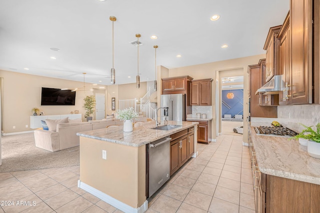 kitchen with visible vents, light tile patterned floors, appliances with stainless steel finishes, brown cabinetry, and a sink