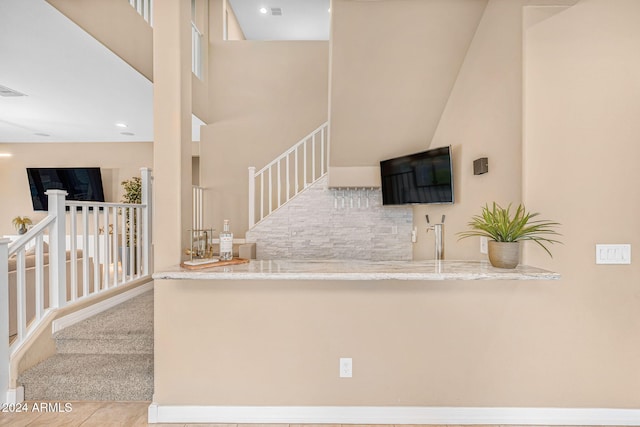 interior space with a towering ceiling and tile patterned floors