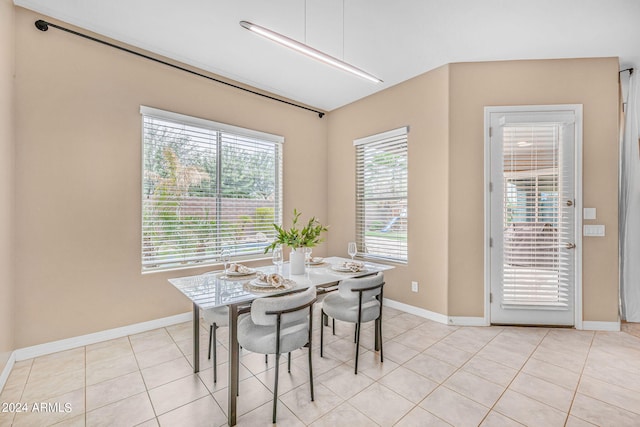 dining room with light tile patterned floors and baseboards