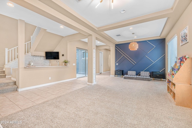 unfurnished living room with tile patterned flooring, stairway, recessed lighting, and carpet