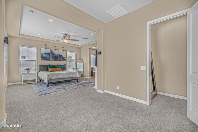 bedroom featuring visible vents, a tray ceiling, recessed lighting, carpet floors, and baseboards