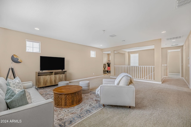 living room featuring visible vents, baseboards, and carpet