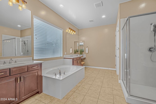 bathroom featuring visible vents, a sink, a shower stall, a garden tub, and tile patterned floors