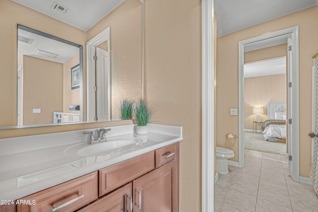 ensuite bathroom with tile patterned floors, visible vents, toilet, connected bathroom, and vanity