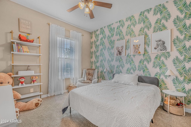 bedroom featuring wallpapered walls, carpet, and baseboards