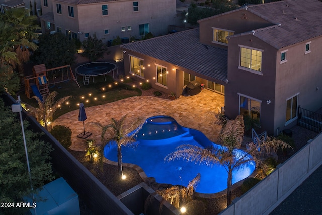 view of pool featuring a playground and a fenced backyard