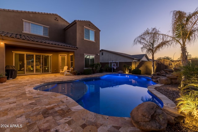 view of swimming pool with a patio, fence, and a fenced in pool