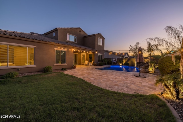 outdoor pool featuring a patio area and a lawn