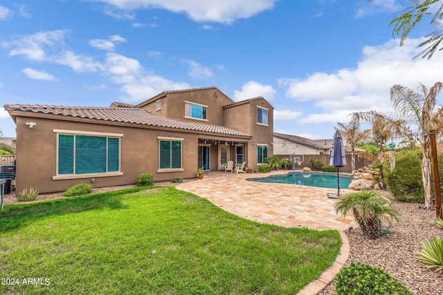 back of house with a fenced in pool, a fenced backyard, stucco siding, a patio area, and a lawn