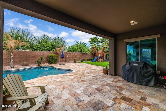 view of swimming pool with a patio, a fenced backyard, a playground, grilling area, and a fenced in pool