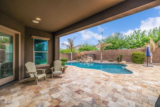 view of swimming pool with a fenced backyard, a fenced in pool, and a patio