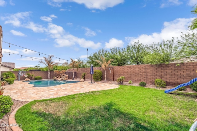 view of yard with a fenced in pool, a patio, and a fenced backyard