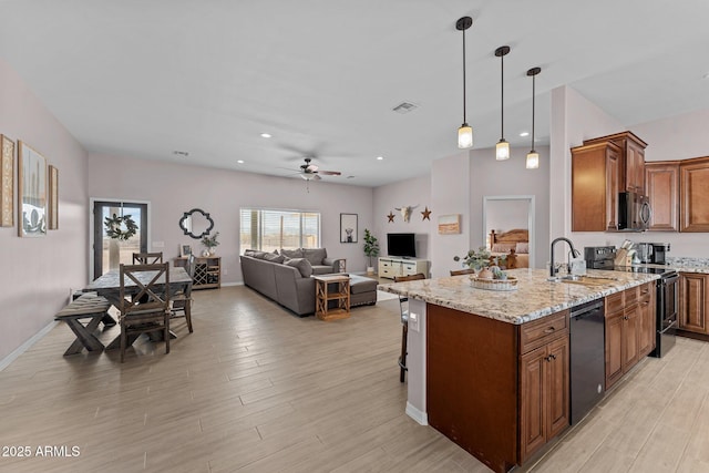 kitchen featuring light stone countertops, pendant lighting, electric range oven, dishwasher, and sink