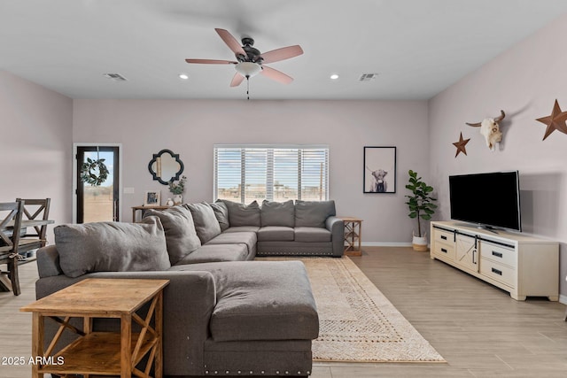 living room featuring ceiling fan and light wood-type flooring