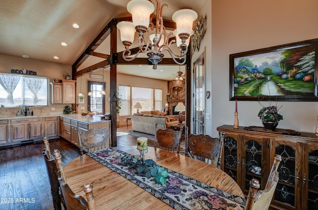 dining room with an inviting chandelier, recessed lighting, high vaulted ceiling, and dark wood finished floors