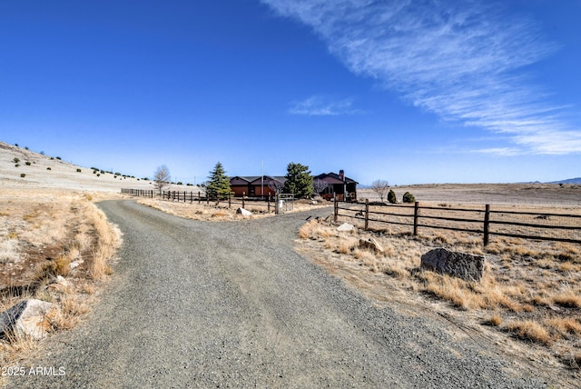 view of road with driveway and a rural view