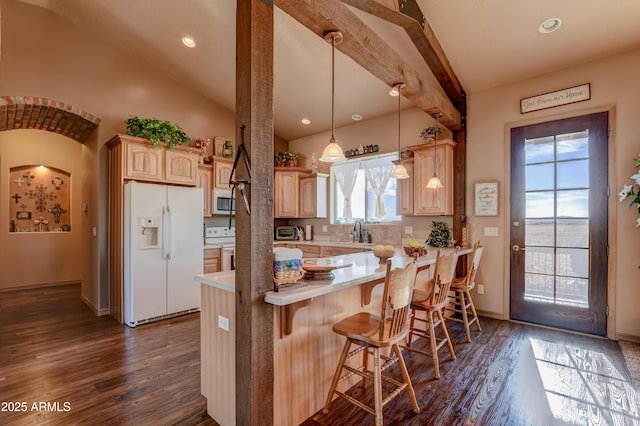 kitchen with light countertops, lofted ceiling with beams, light brown cabinetry, dark wood finished floors, and white appliances