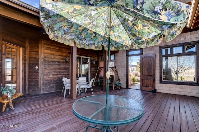 wooden deck featuring outdoor dining area