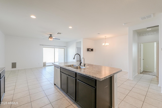 kitchen featuring light tile patterned floors, visible vents, stainless steel dishwasher, a sink, and ceiling fan with notable chandelier