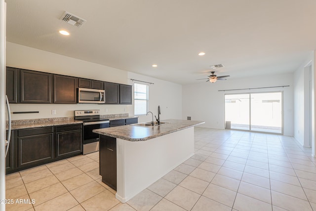 kitchen with light tile patterned floors, stainless steel appliances, recessed lighting, visible vents, and a sink