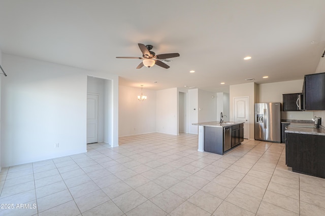 kitchen featuring ceiling fan with notable chandelier, light countertops, a sink, and stainless steel fridge with ice dispenser