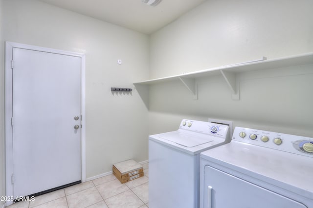 laundry room with laundry area, light tile patterned floors, baseboards, and separate washer and dryer