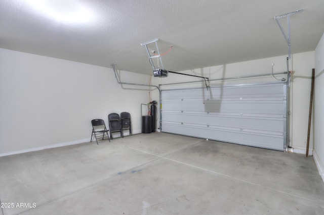 garage with baseboards and a garage door opener