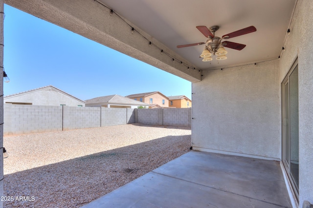 view of patio with a fenced backyard and a ceiling fan