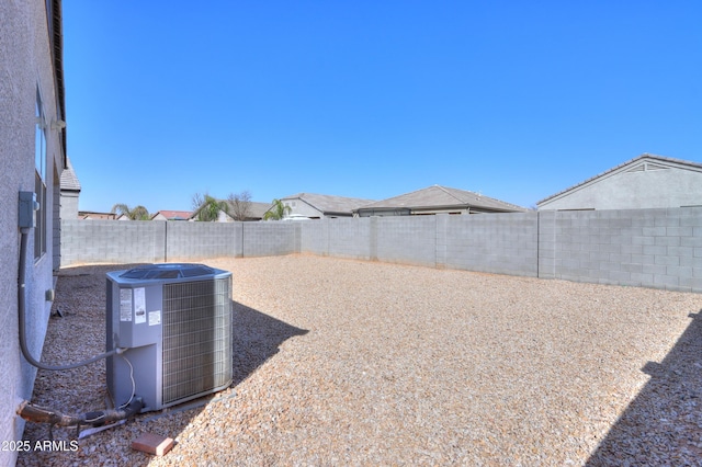 view of yard featuring central AC and a fenced backyard