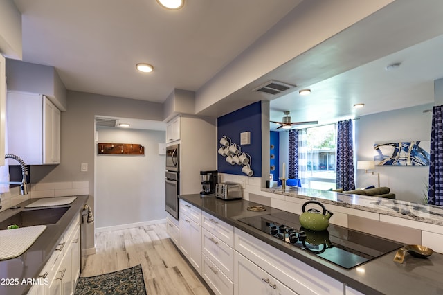 kitchen with white cabinetry, stainless steel appliances, and sink