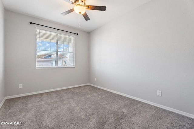 empty room featuring carpet flooring, ceiling fan, and baseboards