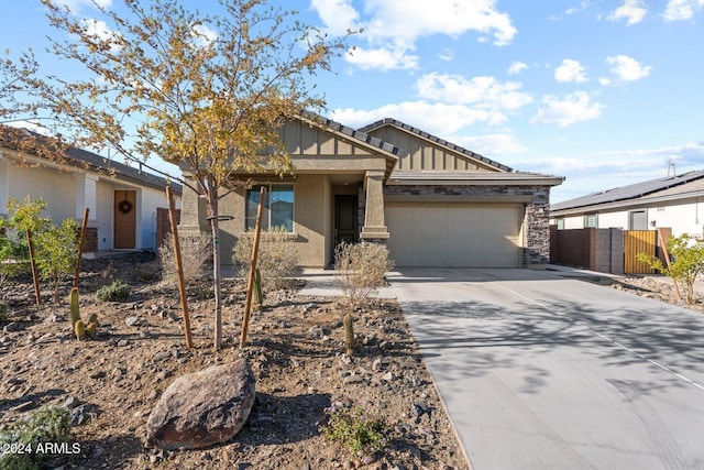 view of front facade with a garage, concrete driveway, fence, board and batten siding, and stucco siding