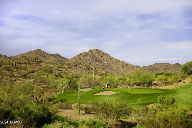 view of home's community featuring view of golf course and a mountain view