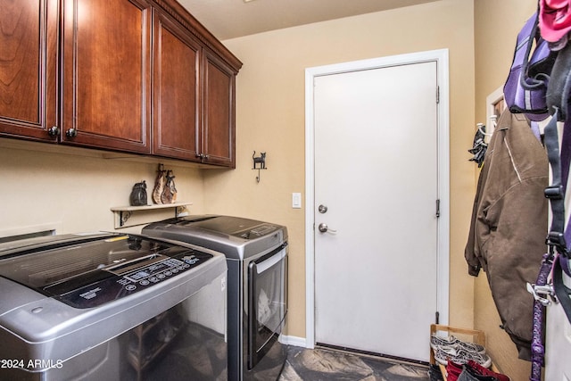 laundry area with cabinets and washing machine and clothes dryer